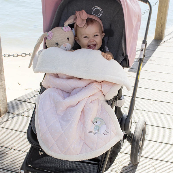 Baby in Pram with knitted toy and thick winter quilted baby blanket