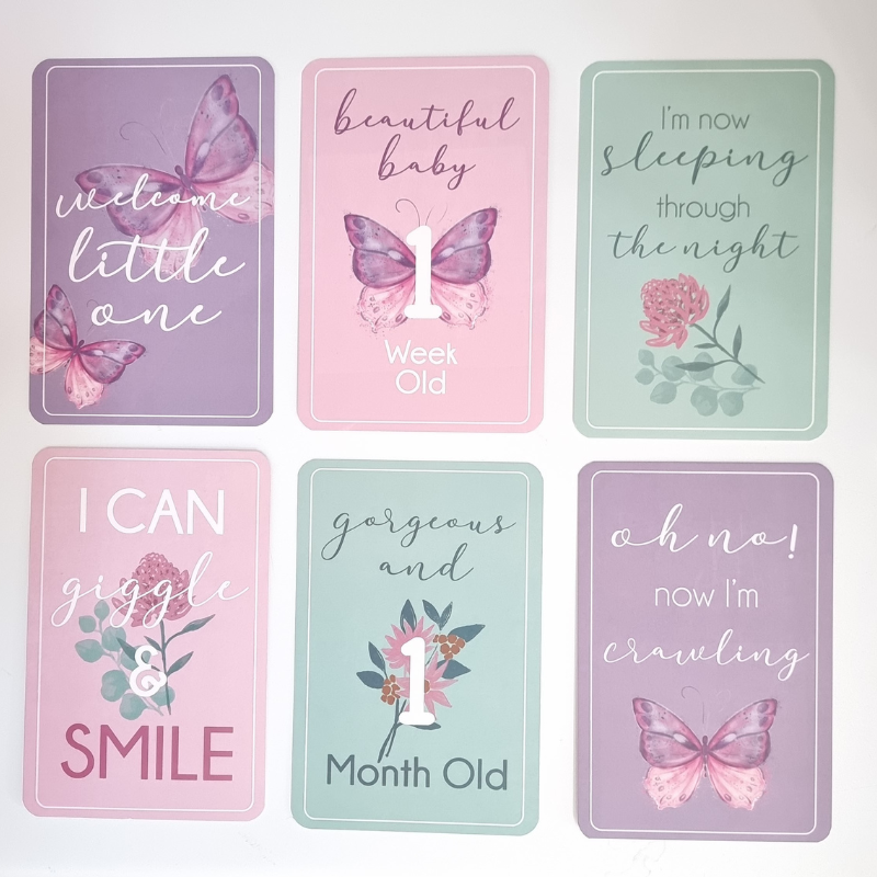 Set of milestone cards with butterfly designs and text on a white background