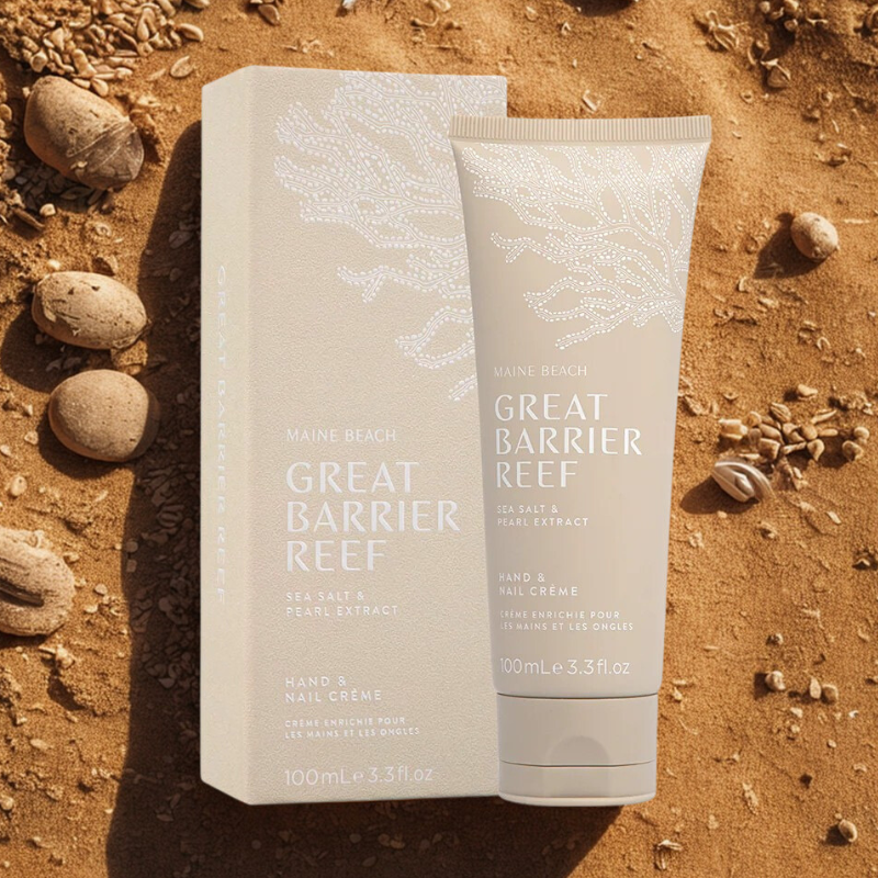 Maine Beach Great Barrier Reef hand and nail crème packaging on a sandy background