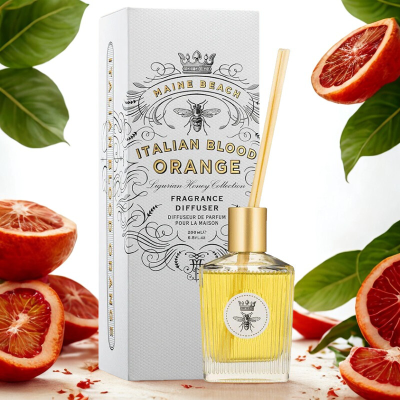 Fragrance diffuser with packaging and blood oranges on a light background