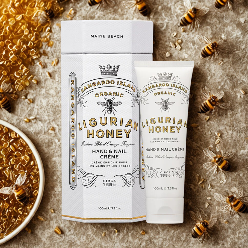 Kangaroo Island Organic Ligurian Honey hand and nail crème packaging with bees and honeycomb on a textured surface.