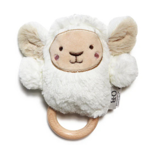 A soft white teether toy in the shape of a lamb with a wooden ring attached for teething.