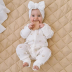 baby with silicone teether wearing ocean design shell print baby romper