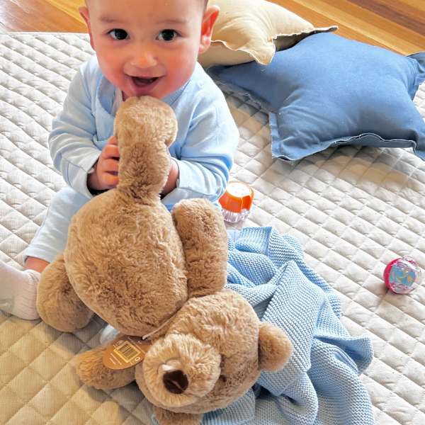 baby sitting with baby soft teddy bear and personalised blanket