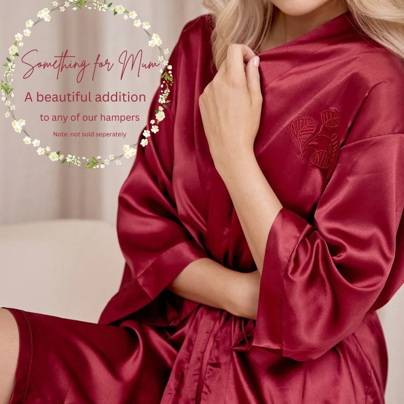Red satin robe with floral design, suitable for a Mother's Day gift, on a neutral background.