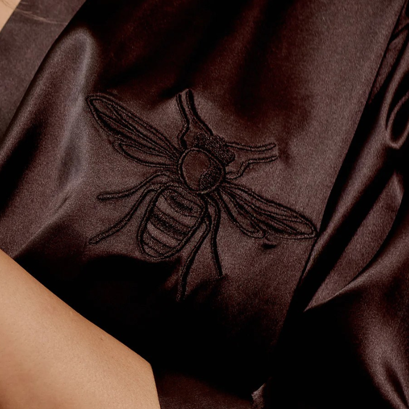 Embroidered bee design on black satin womans bath robe.