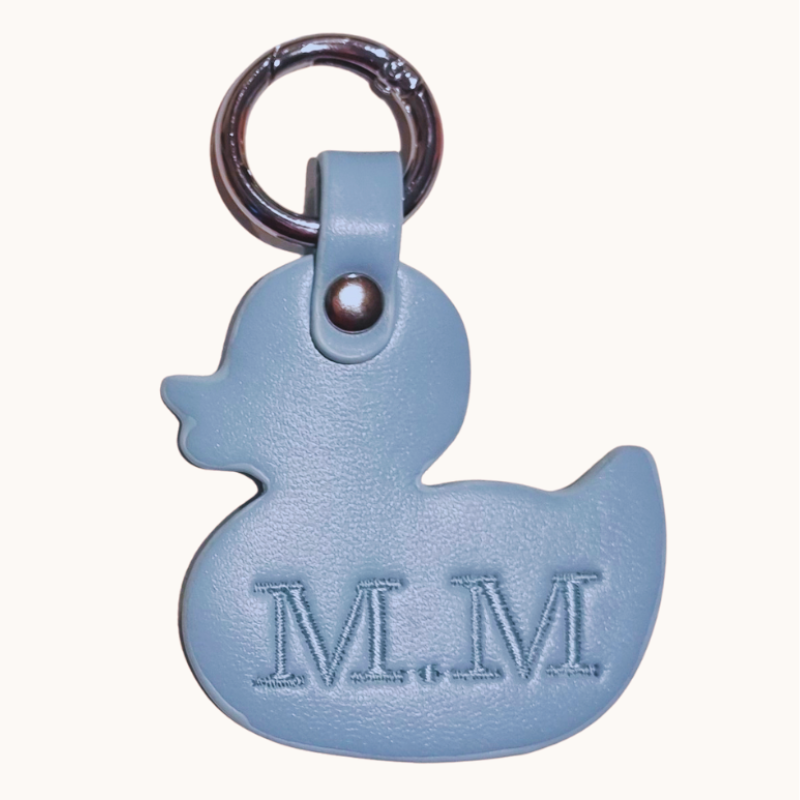 Blue rubber duck keychain with 'M.M' initials on a white background
