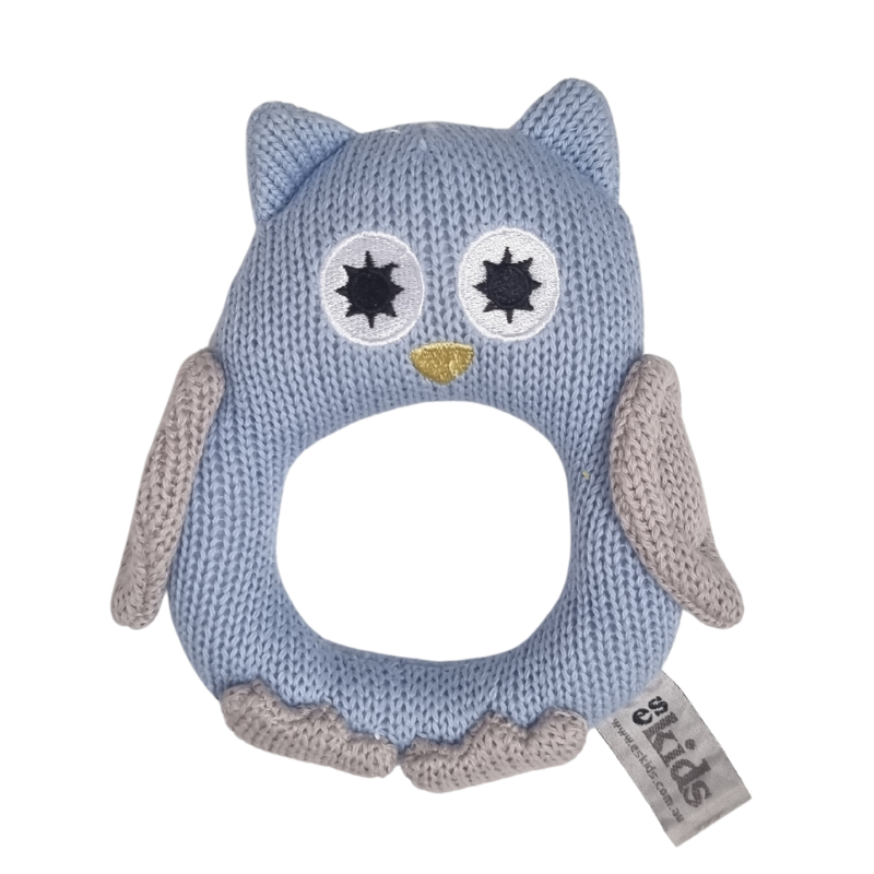 Blue knitted owl rattle with a gold beak on a white background
