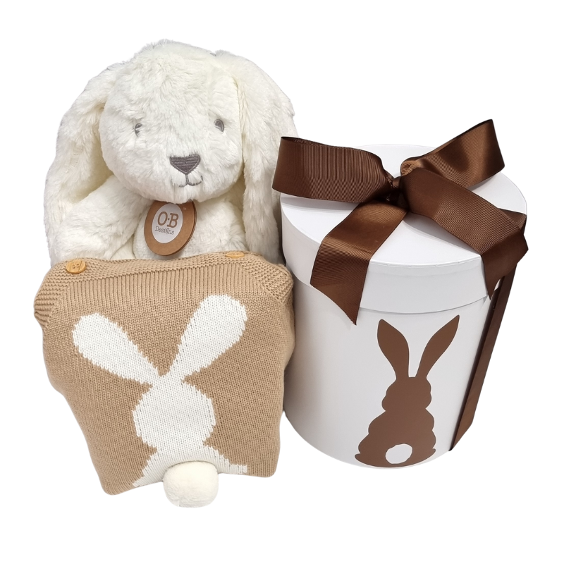 A baby gift hamper set including a neutral toned knitted bunny romper, a plush bunny toy, and a gift hat box with a bunny silhouette design.