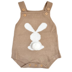 A baby gift  including a neutral toned knitted bunny romper, 