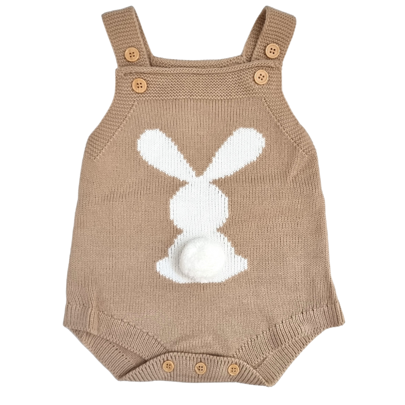 A baby gift  including a neutral toned knitted bunny romper, 