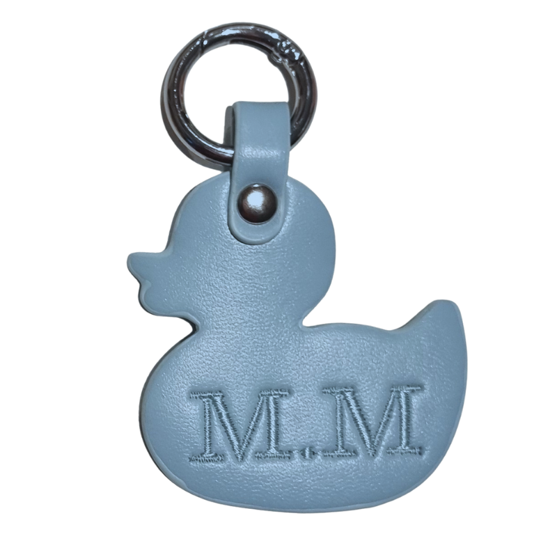 Blue rubber duck keychain with 'M.M' initials embroidered on a white background