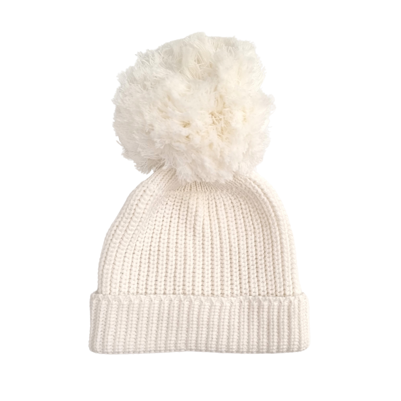 A beige chunky knit baby beanie with a pom pom on top.