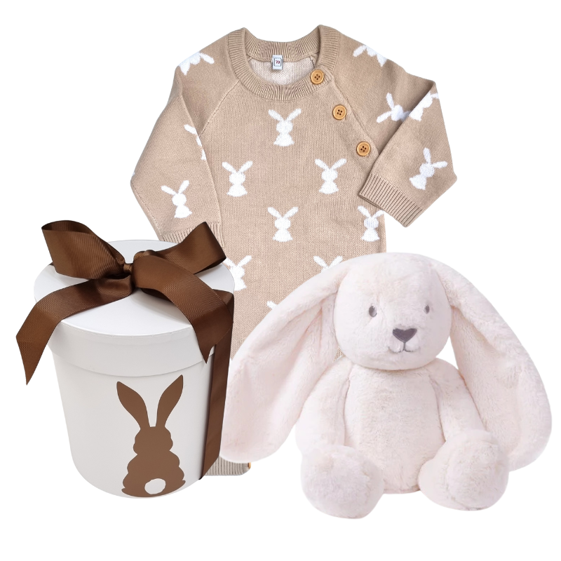 A baby gift hamper set including a beige and white knitted romper with bunny patterns, a beige plush bunny toy, and a white gift box with a bunny design and a brown ribbon.