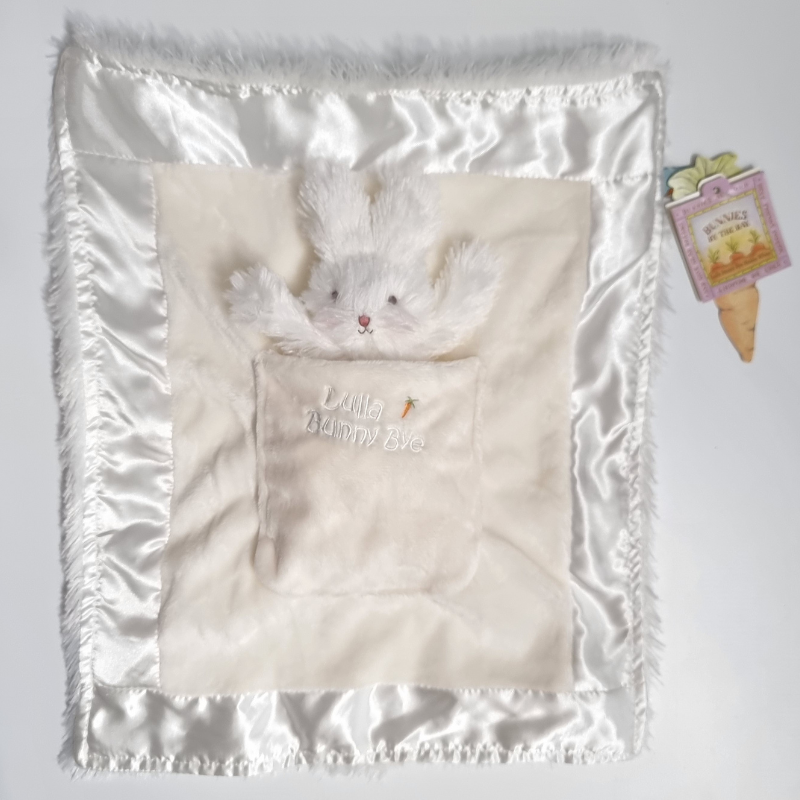 A white baby comforter with a plush bunny design in the center, featuring a soft plush backing and a velour and satin front.