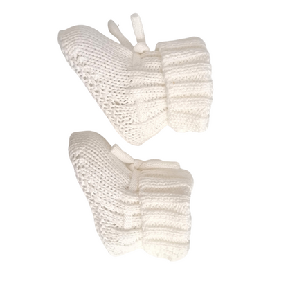 A pair of white chunky knitted baby booties.
