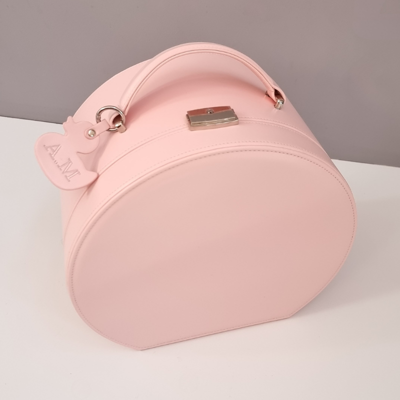 Pink baby keepsake box with a personalised ducky key tag on a light gray background