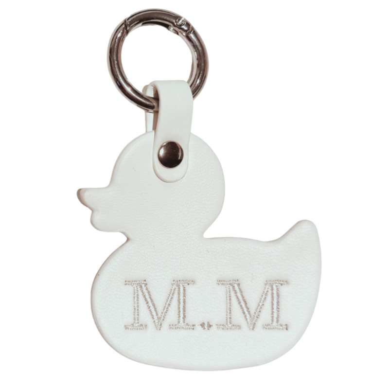 White rubber duck-shaped keychain with 'M.M' engraving on a white background
