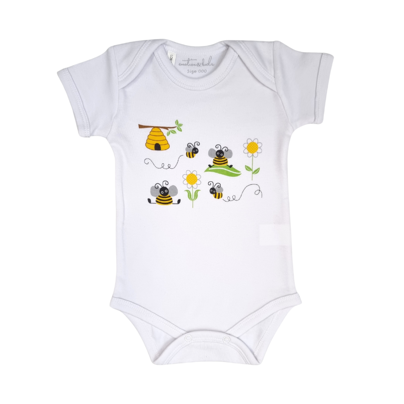 A white baby onesie with a bumble bee design, including bees, a beehive, and daisies.