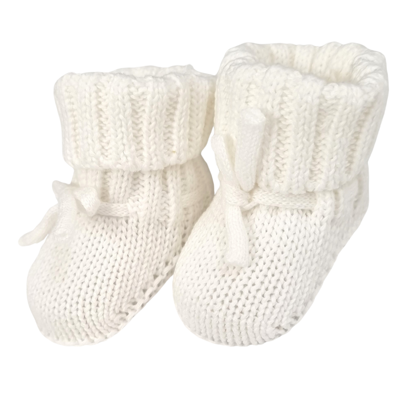 A pair of white chunky knitted baby booties.
