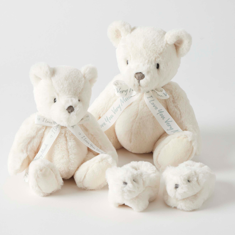 Set of cream-colored teddy bears with small white teddy bears slippers on a light gray background