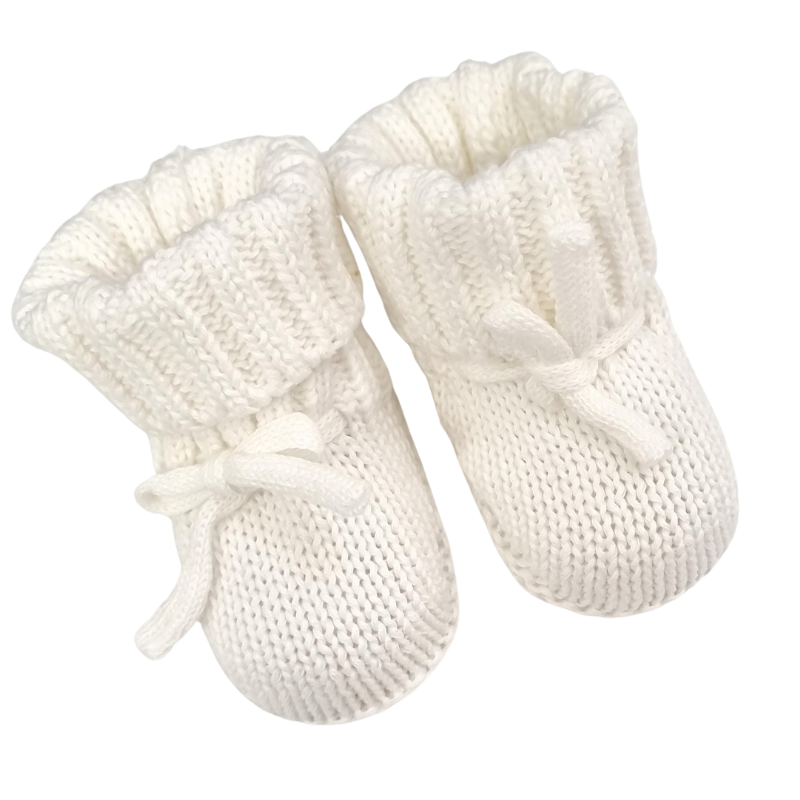 A pair of white chunky knitted baby booties.