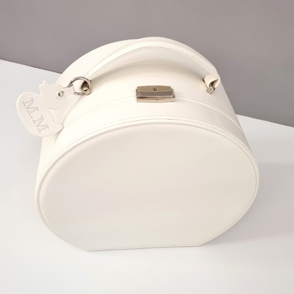 White baby keepsake gift box with a strap and personalised key tag on a gray background