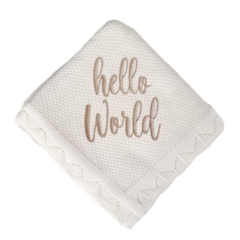 White knitted blanket with 'hello world' embroidery on a white background