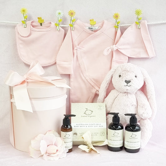 Organic baby girls pink hamper with beanie, suit, bib, bathwash, moisturiser and bottom cream.