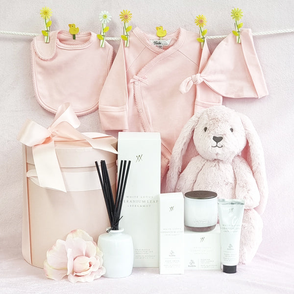 Mama and baby girls organic pink gift hamper with suit, beanie, bib, soy candle, room diffuser and hand cream.