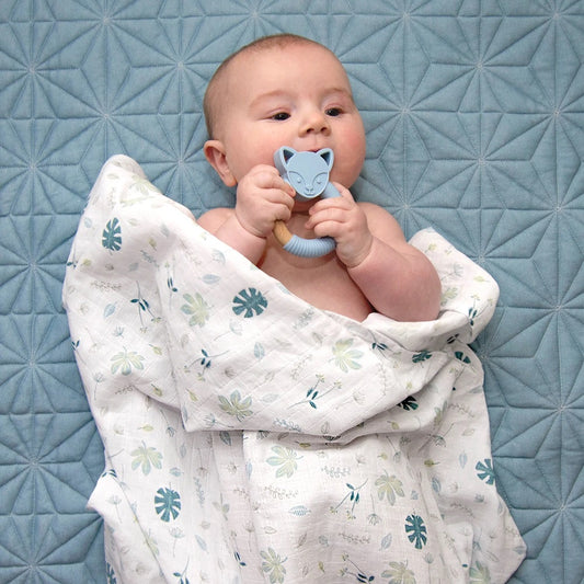 organic muslin sage green banana leaf design baby swaddle with silicone and wooden fox teether.