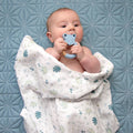 organic muslin sage green banana leaf design baby swaddle with silicone and wooden fox teether.