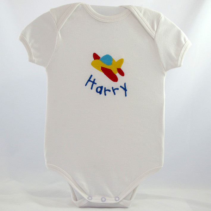 personalised baby body suit embroidered with a planes design and the baby name
