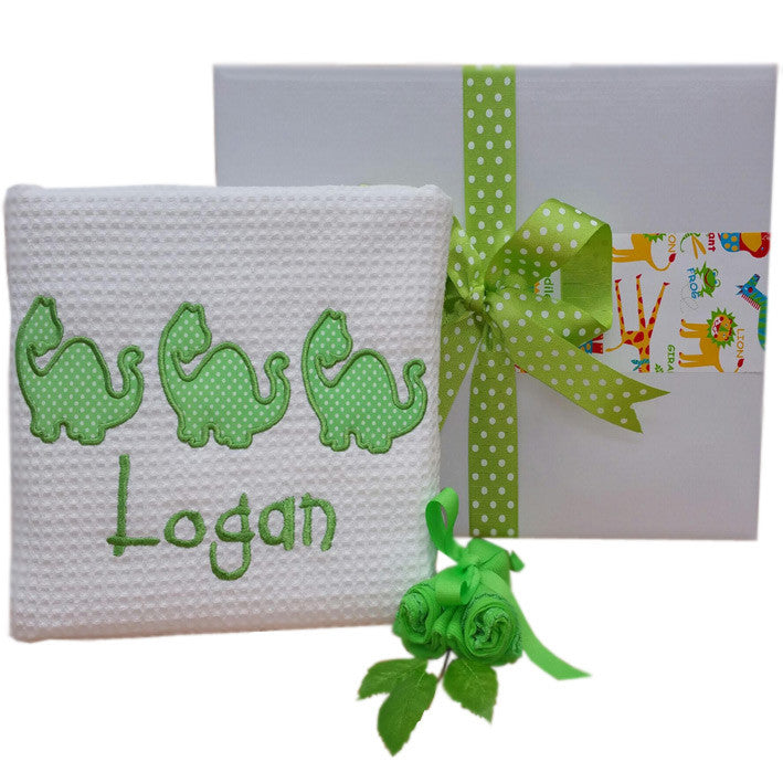 personalised baby blanket dinosaur design baby gift hamper. 100% cotton baby cot blanket with baby's name and 3 dinosaur design