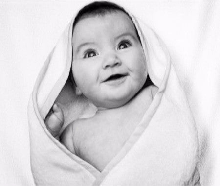 baby wrapped in baby hooded bath towel
