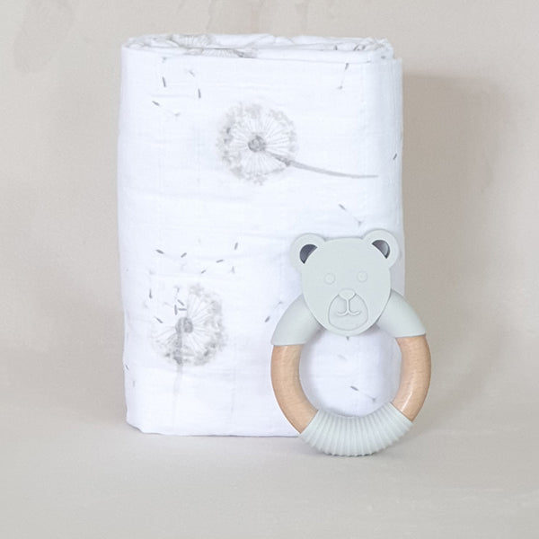 organic muslin grey dandelion design baby swaddle with silicone and wooden bear teether.