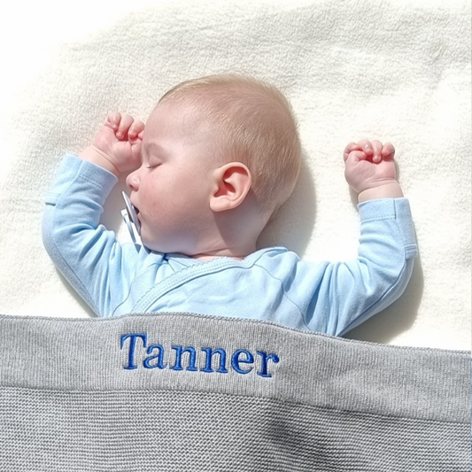 personalised knitted baby blanket grey with royal blue font