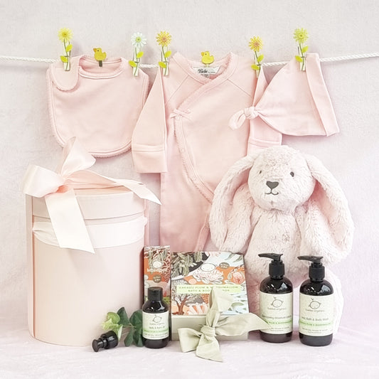 Organic girl baby hamper with pink bib suit beanie and soft bunny with Kakadu Plum baby bath wash moisturiser and belly oil.