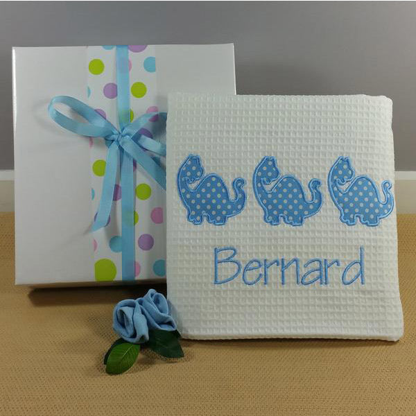 Personalised baby boy dinosaur cot blanket. 100% cotton waffle baby blanket with 3 dinosaur motif and babies name